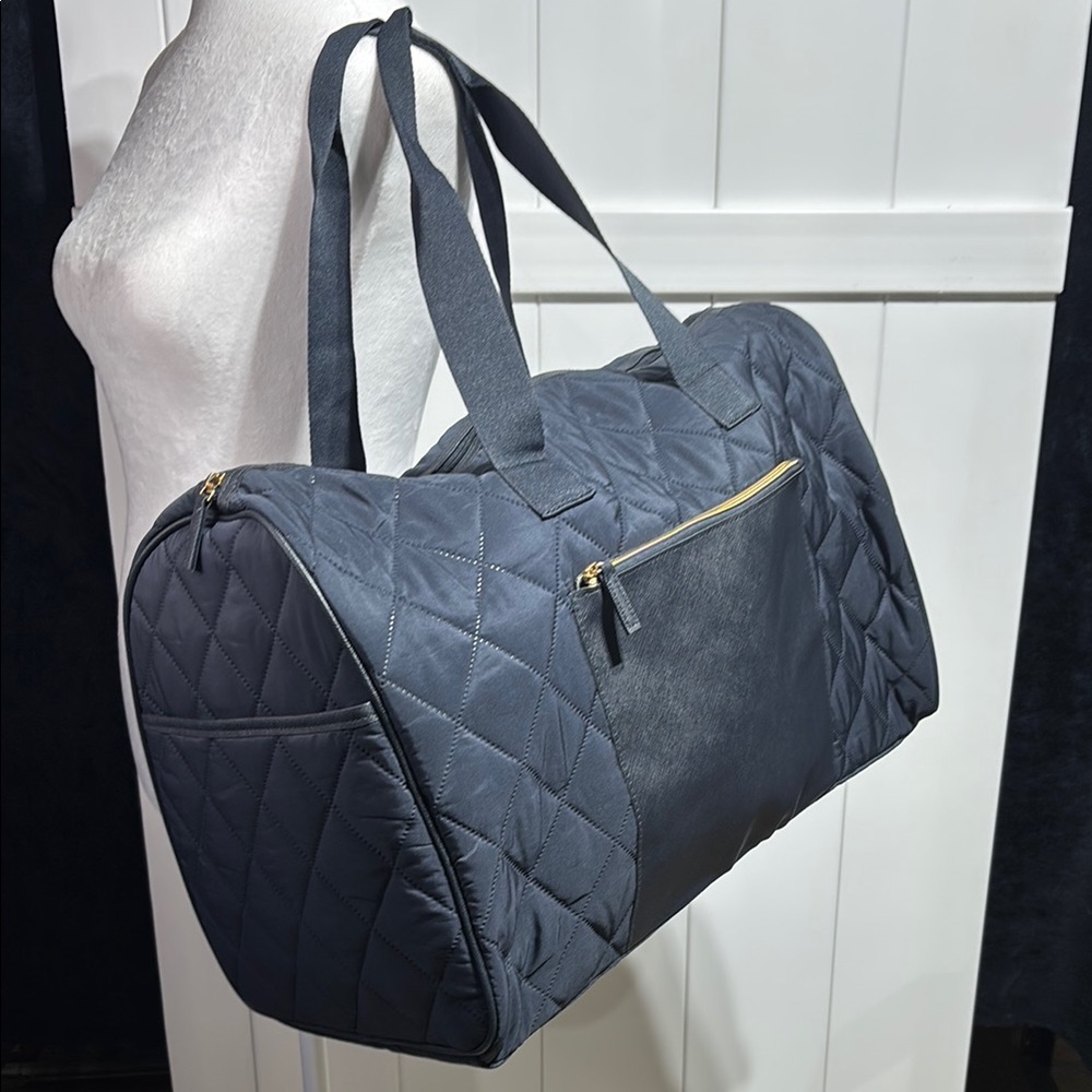 Large navy quilted duffel bag with handles